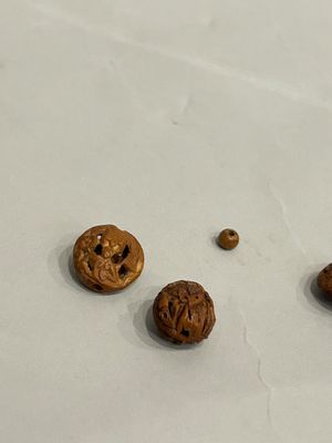three pieces of walnuts on a white surface