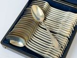 silverware in a blue case with spoons and spoons in it