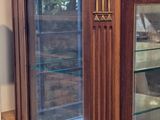 a display case with a marble top and glass doors
