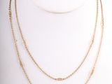a close up of a gold necklace on a mannequin mannequin