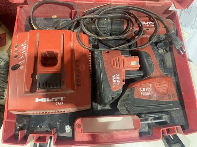 a red box with tools in it sitting on a table