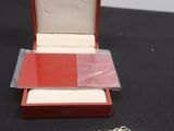 une image représentant une boîte rouge et blanche à laquelle est attachée une chaîne