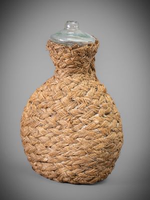 an image of a woven vase with a glass lid