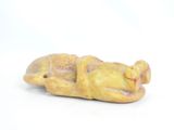 a figurine of a person laying down on a white surface