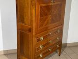 a wooden chest of drawers in a room with tile flooring