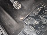a close up of a car ' s floor mat with tools on it