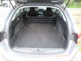 the back of a car with the trunk open and the seats down
