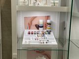 a glass display case with a lot of jewelry on it