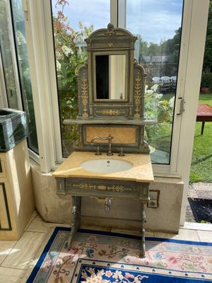 a bathroom with a sink, mirror and rug in it