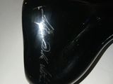 a close up of a black shoe with writing on it