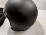 a black helmet sitting on a table next to a pair of shoes