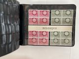 a black case with stamps inside of it on a table