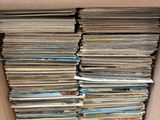 an open cardboard box filled with lots of cds and cds