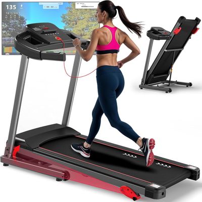 the woman is running on the tread machine in front of the monitor