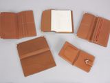 several pieces of brown leather are arranged on a white surface