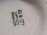 a close up of a white bowl with green writing on it