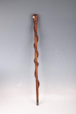 an old wooden walking stick with a twisted handle on a white background