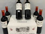 six bottles of red wine sit in a display case
