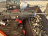 an image of a drill and screws in a box