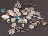 a lot of silver charms on a black surface