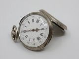 a silver pocket watch with roman numerals on it