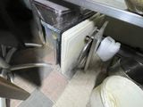 an image of a kitchen with a sink and a trash can