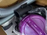 a purple vacuum that is sitting in a box