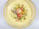 a plate with flowers on it on a white surface