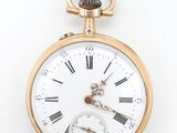 a gold pocket watch with roman numerals on it