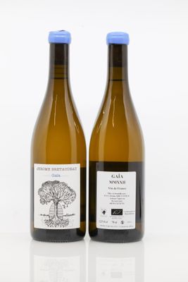 two bottles of wine sitting next to each other on a white surface