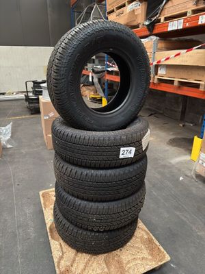 four tires stacked on top of each other in a warehouse