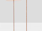 a pair of brass floor lamps on a white surface