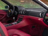 the interior of a sports car with red leather seats and steering controls