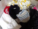 a basket full of clothes that is sitting on the floor