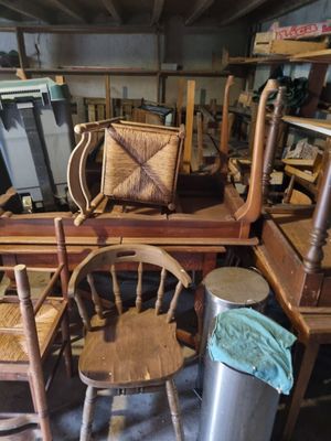 a pile of chairs and a table in a room