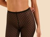 the woman is wearing a black bra top and black shorts
