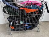 a metal shopping cart filled with luggage on the floor