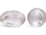 pair of silver plated bowls on a white surface with a white background