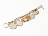 a close up of a silver bracelet with coins on it