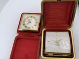a small box with a watch inside of it on a table