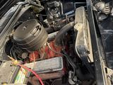 a black car with an open hood and an engine