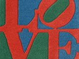 a close up of a red, green and blue love sign