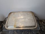 a silver tray with a metal lid on a marble table
