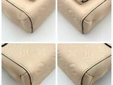 four photos of a beige purse with a zipper on the inside