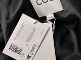 a close up of a black jacket with a tag on it