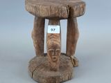 un vieux tabouret en bois sur lequel est posée une pancarte