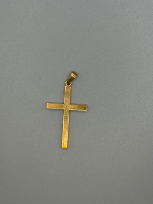 a gold cross on a gray background