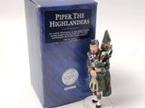 a figurine of a man playing the bagpipe