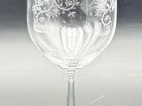 a wine glass that has a red label on it