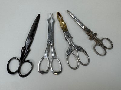 five pairs of scissors sitting next to each other on a table